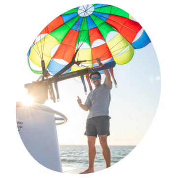 Instructor adjusting the parachute for Parasailing