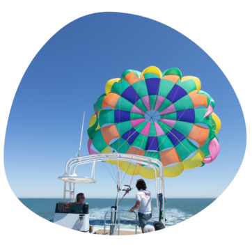 People on a boat going Parasailing