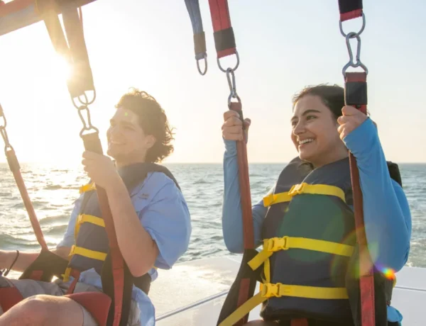 Smiling girls fly with us in Parasailing